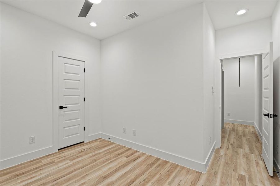 Spare room featuring ceiling fan and light hardwood / wood-style flooring