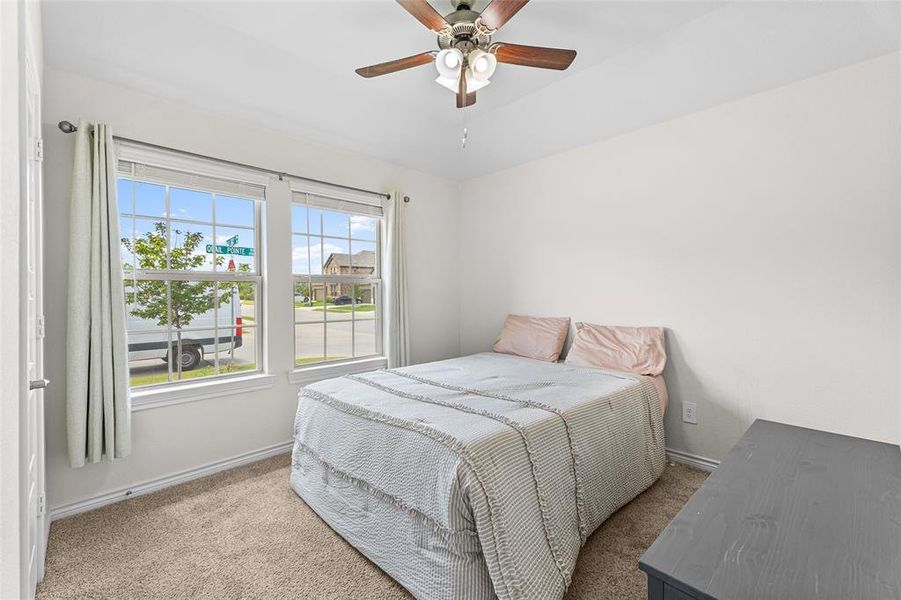 Bedroom with carpet flooring and a ceiling fan Bedroom with carpet flooring and a ceiling fan