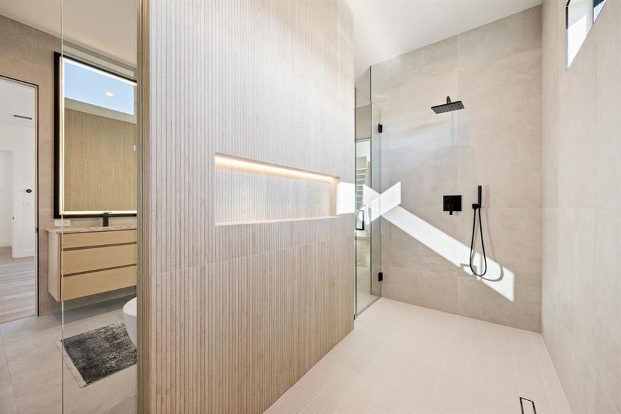 Oversized walk-in shower with sleek modern tile. Oversized walk-in shower with sleek modern tile.