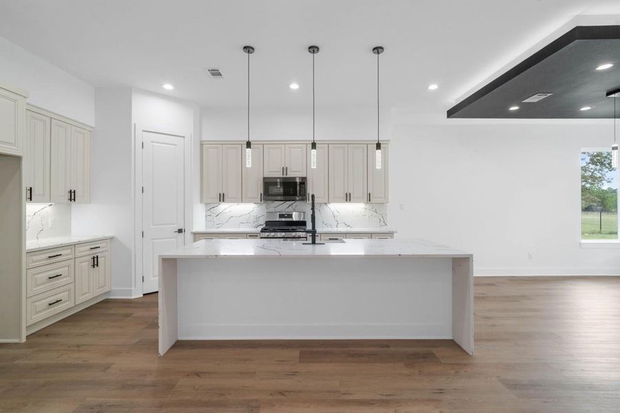 Nice spacious kitchen, with ample lighting and an island with amazing backspash and nice wooden cabinets. Nice spacious kitchen, with ample lighting and an island with amazing backspash and nice wooden cabinets.
