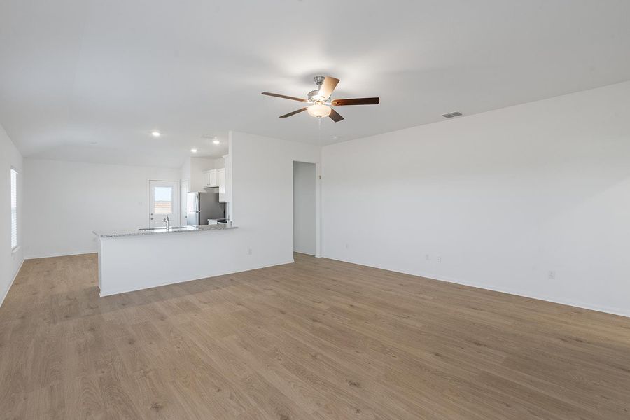An open floorplan seamlessly connects the well-lit living area to a practical kitchen space. An open floorplan seamlessly connects the well-lit living area to a practical kitchen space.
