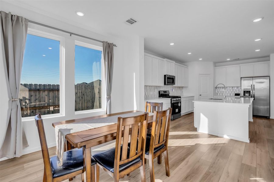 Dining Area: Positioned beside oversized windows, this space is filled with natural light and flows directly into the kitchen. Ideal for everyday meals or hosting, with clear connection to the heart of the home. Dining Area: Positioned beside oversized windows, this space is filled with natural light and flows directly into the kitchen. Ideal for everyday meals or hosting, with clear connection to the heart of the home.