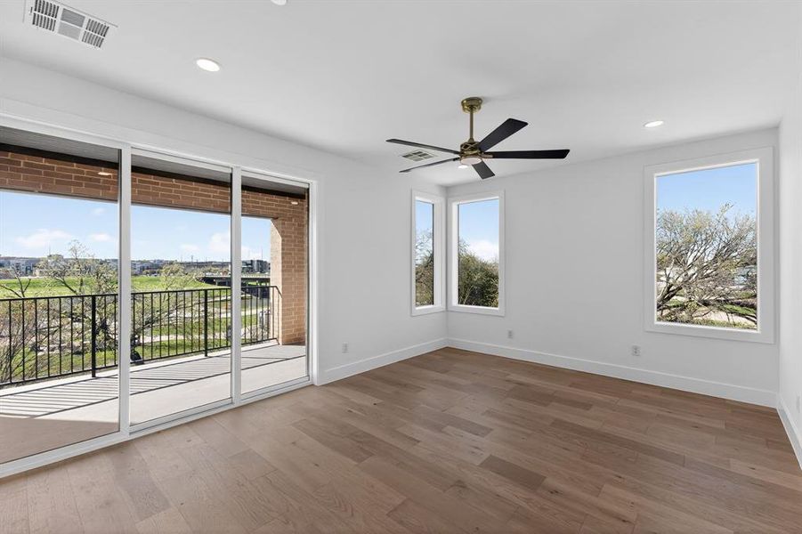Primary bedroom featuring ceiling fan, dark wood-style floors, and recessed lighting