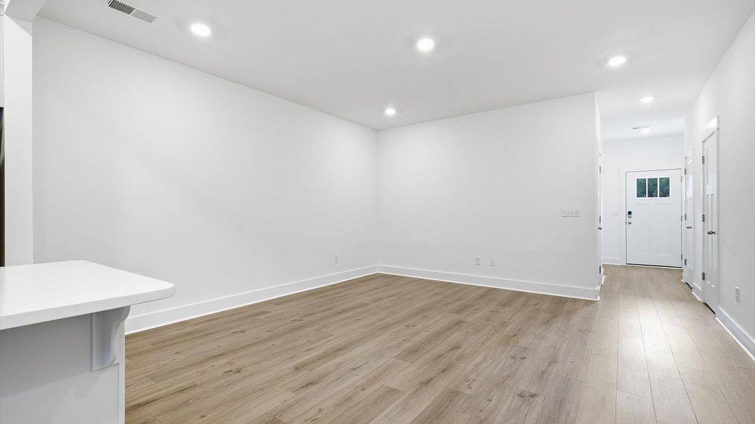 Tasteful family room with high ceilings, modern fixtures, and a warm, inviting feel by DRB Homes