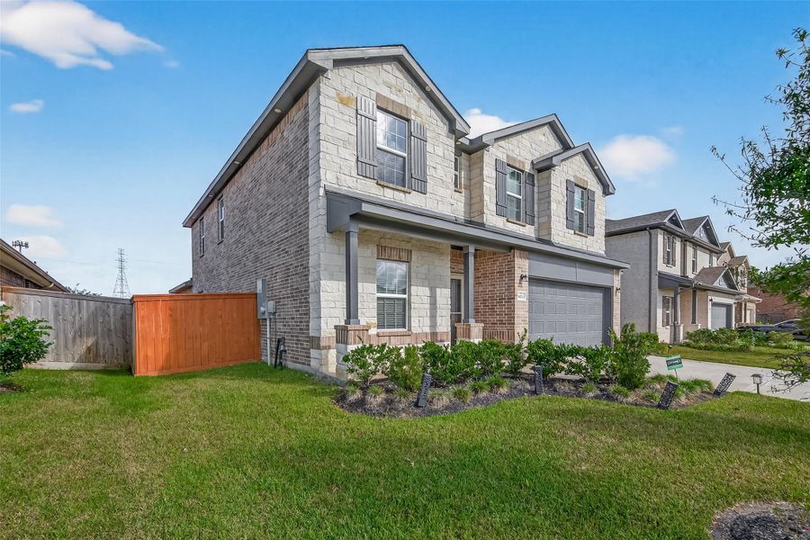 Front exterior of a new home in Massey Oaks, Pearland, TX, highlighting curb appeal (Image 2).
