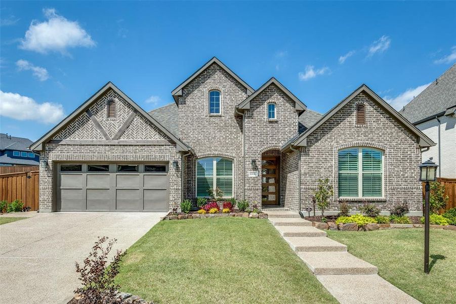 Paradise Village Yard of the Month winner! Exceptional curb appeal makes this home a standout in the community.
