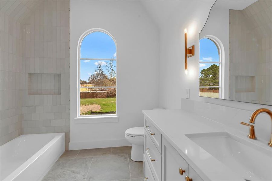 Full bathroom featuring vanity, a bath, and light tile patterned flooring