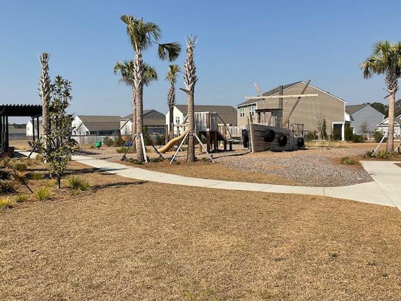Front exterior of a new home in Pender Woods at Cane Bay, Summerville, SC, highlighting curb appeal (Image 18).