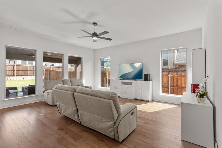Living area featuring wood finished floors and a ceiling fan