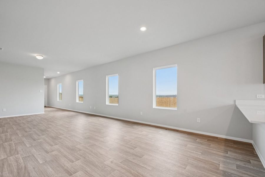 Image of a living room with light grey walls, white trim and windows