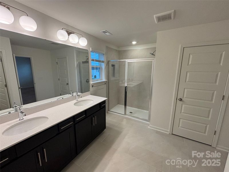 Primary Bath features dual sink vanity, ceramic tile in shower, private water closet and linen closet. Primary Bath features dual sink vanity, ceramic tile in shower, private water closet and linen closet.