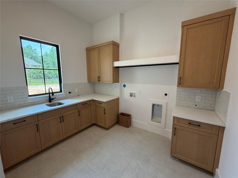 Make doing laundry a pleasure in this oversized Utilty Romm with built ins, lots of counter space & sink Make doing laundry a pleasure in this oversized Utilty Romm with built ins, lots of counter space & sink