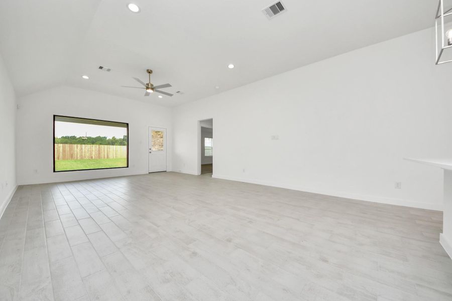 Family room flooded with natural light through the expansive windows. The premium tile flooring adds a touch of luxury to the space, creating the perfect setting for relaxing moments and cherished gatherings with loved ones. Sample photo of completed home with similar floor plan. Actual colors and selections may vary. Family room flooded with natural light through the expansive windows. The premium tile flooring adds a touch of luxury to the space, creating the perfect setting for relaxing moments and cherished gatherings with loved ones. Sample photo of completed home with similar floor plan. Actual colors and selections may vary.