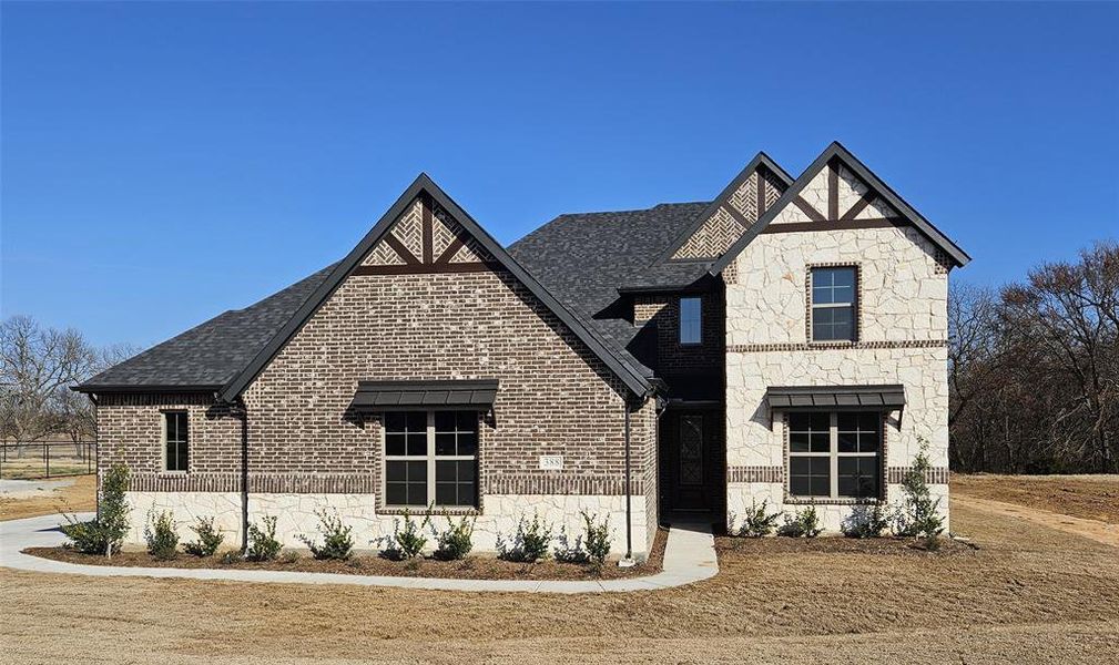 Front exterior of a new home in Pecan Grove, Whitesboro, TX, highlighting curb appeal (Image 1). Front exterior of a new home in Pecan Grove, Whitesboro, TX, highlighting curb appeal (Image 1).