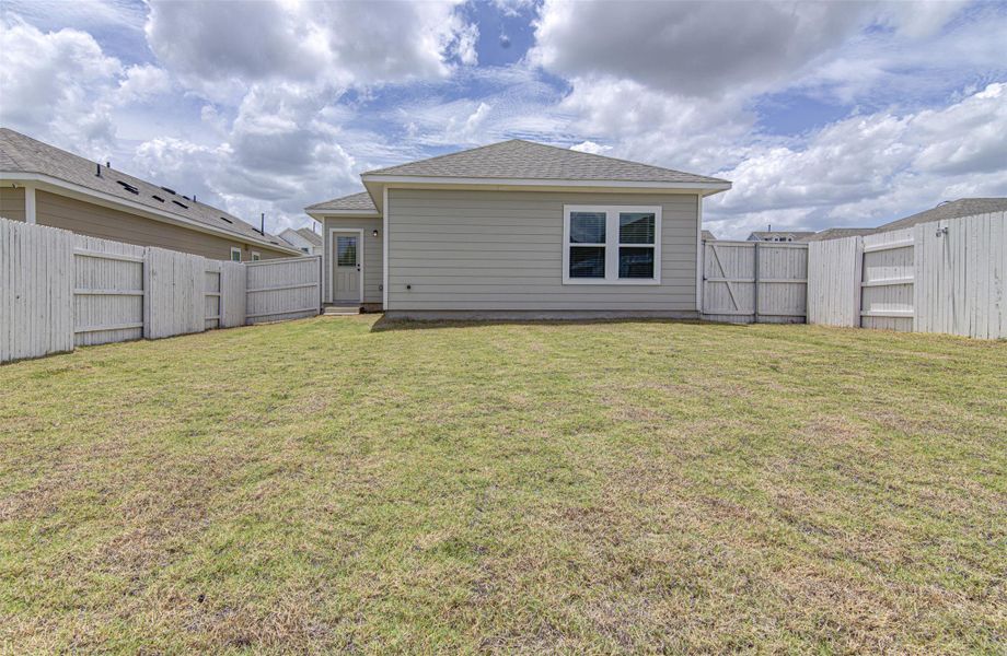 A generous backyard, fully enclosed with privacy fencing, offers ample space for outdoor living. A generous backyard, fully enclosed with privacy fencing, offers ample space for outdoor living.
