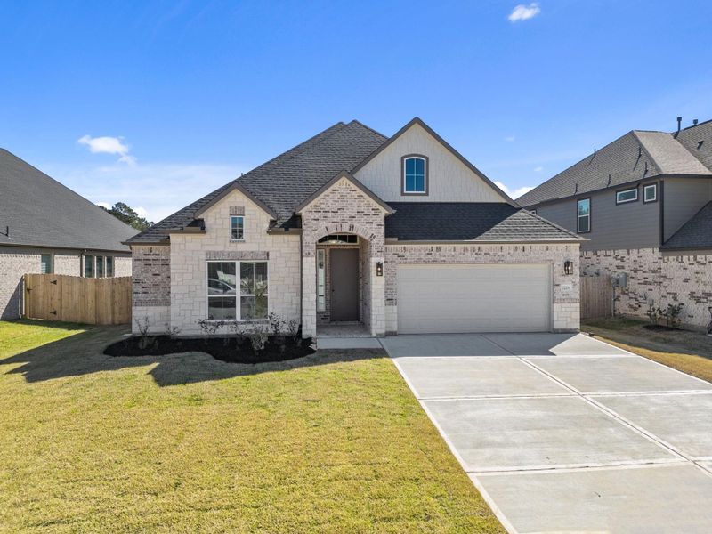 Front exterior of a new home in Barton Creek Ranch, Conroe, TX, highlighting curb appeal (Image 15).