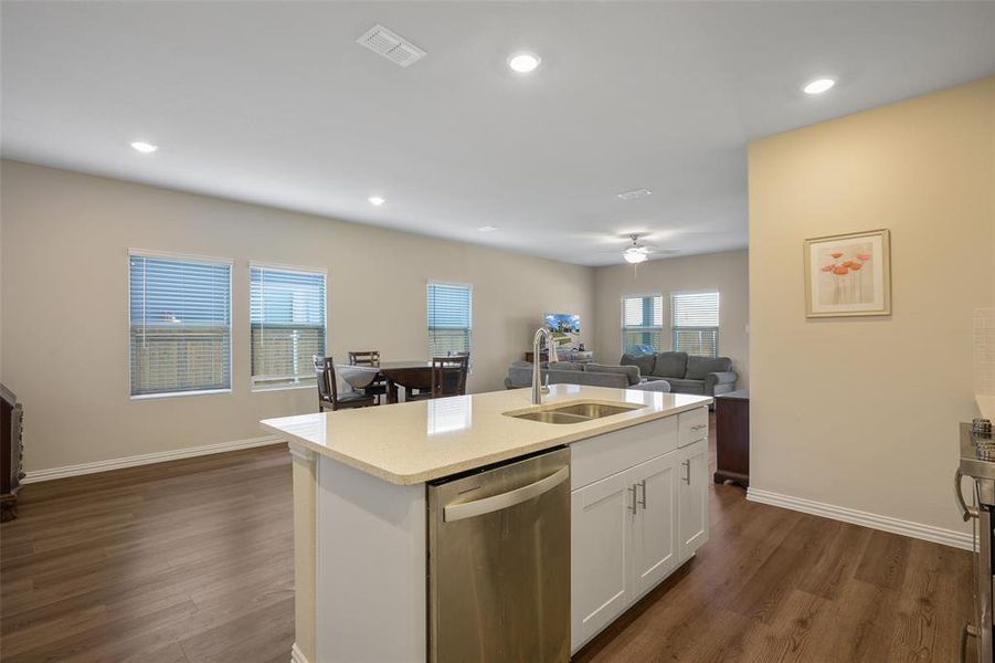Kitchen island with a light-toned countertop and an integrated double basin sink Kitchen island with a light-toned countertop and an integrated double basin sink