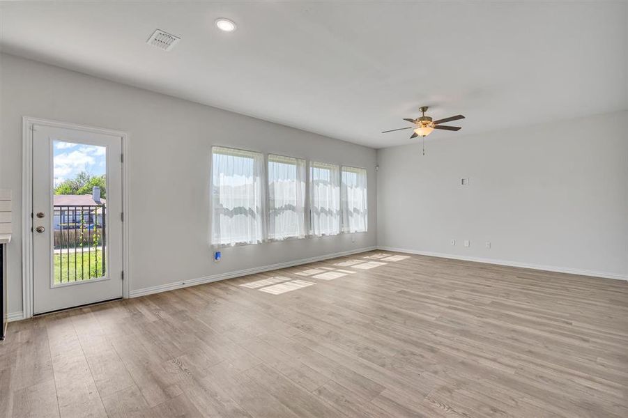 Unfurnished room with light hardwood / wood-style flooring and ceiling fan