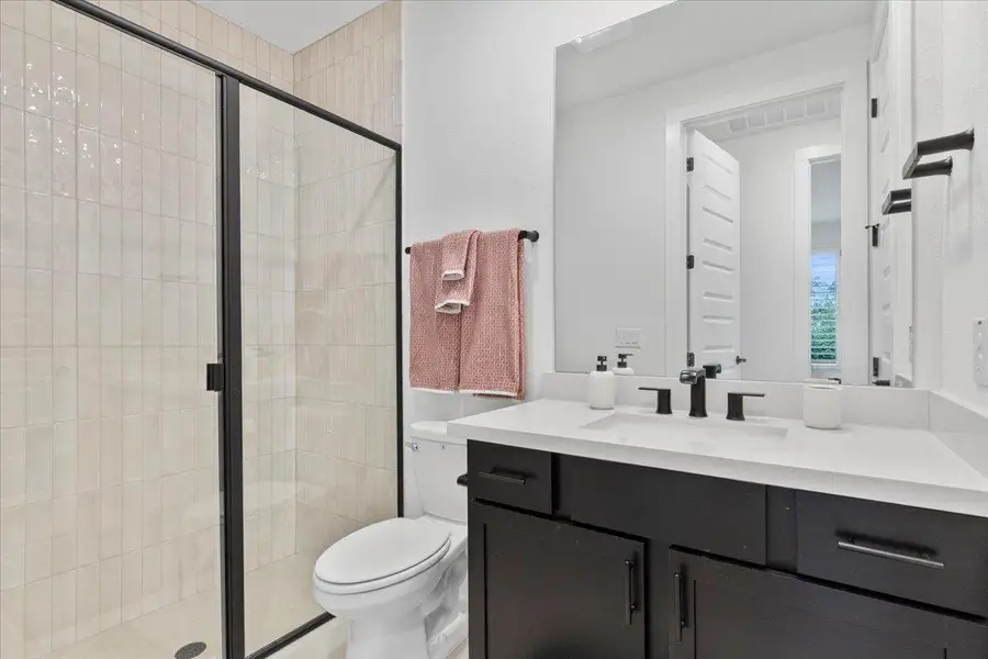 Full bath with vanity and a stall shower