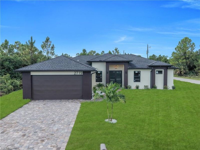 Front exterior of a new home in , Lehigh Acres, FL, highlighting curb appeal (Image 27).