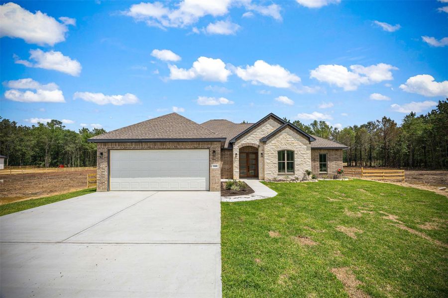 Front exterior of a new home in , Dayton, TX, highlighting curb appeal (Image 25).