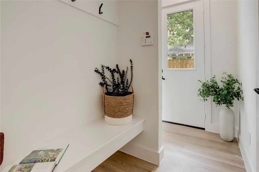 Upon entering there is a convenient mud room with built-in bench and hooks. Upon entering there is a convenient mud room with built-in bench and hooks.
