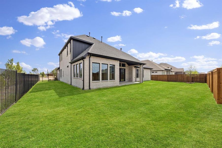 Featuring a spacious covered back patio and fenced yard, the entire family can enjoy the great outdoors in this dream home!