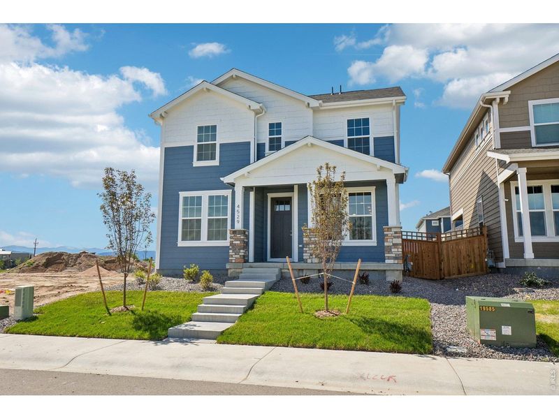 Front exterior of a new home in Timnath Lakes, Timnath, CO, highlighting curb appeal (Image 2). Front exterior of a new home in Timnath Lakes, Timnath, CO, highlighting curb appeal (Image 2).