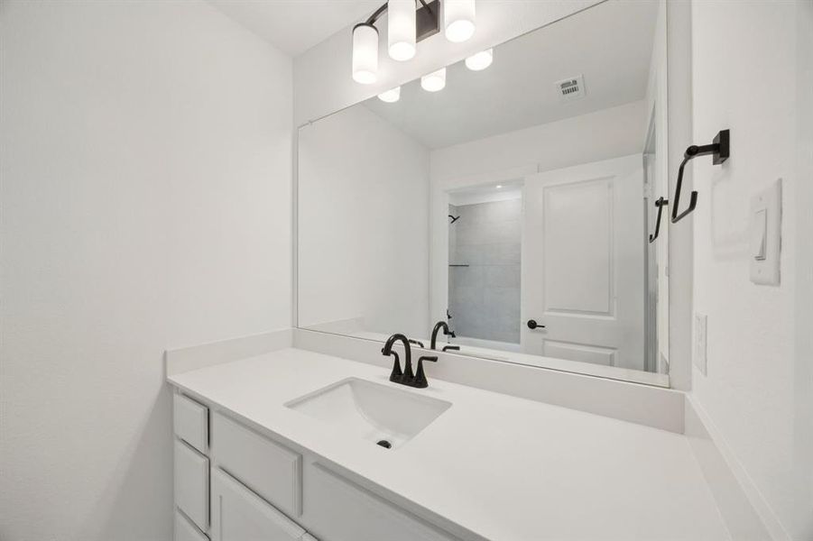 Full bath featuring vanity and a tile shower Full bath featuring vanity and a tile shower