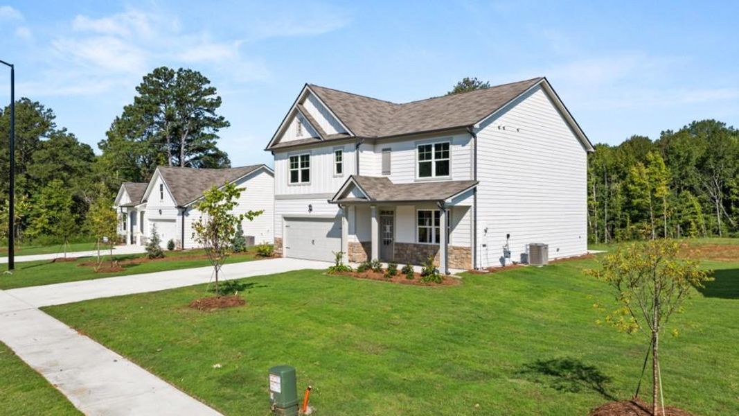 Front exterior of a new home in Fairhaven, Lithia Springs, GA, highlighting curb appeal (Image 29). Front exterior of a new home in Fairhaven, Lithia Springs, GA, highlighting curb appeal (Image 29).