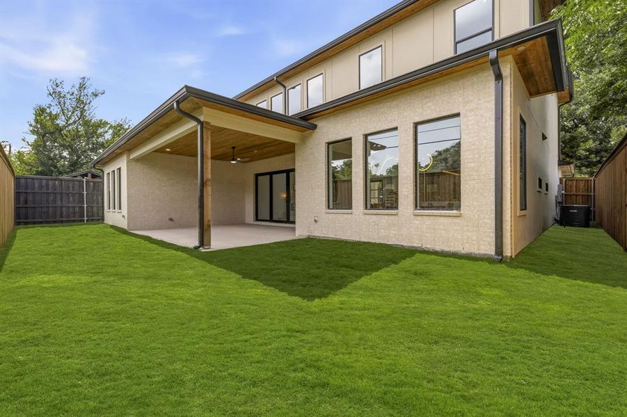 Rear exterior featuring a covered patio with wood-finish ceiling, exposed beam, and ceiling fan