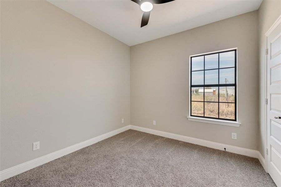 Spare room featuring ceiling fan and light colored carpet