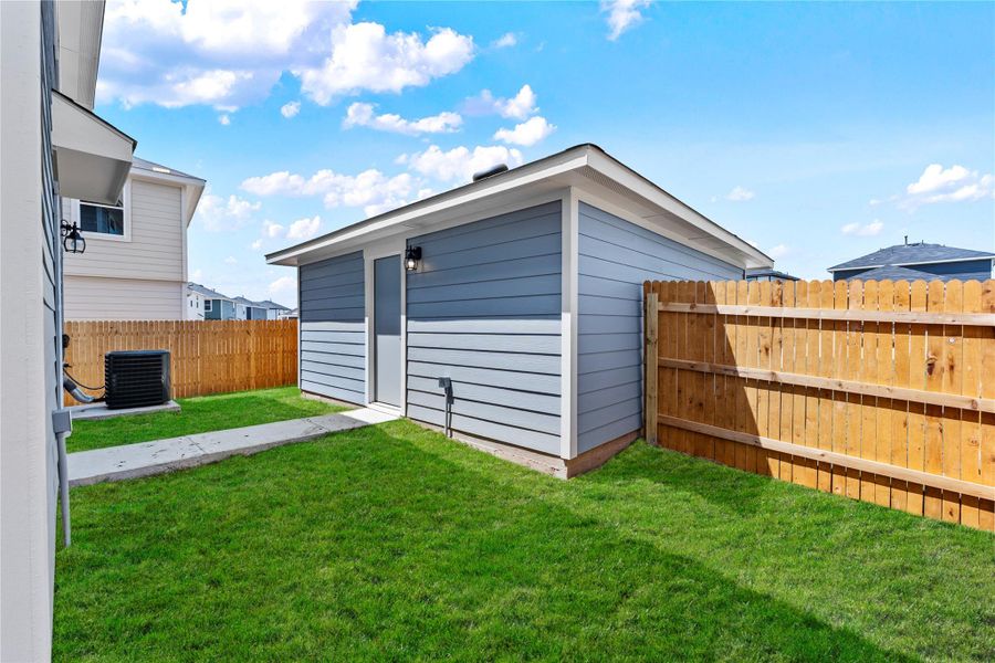 Exterior details and patio area of a home in Prairie Lakes, Buda (Image 14).