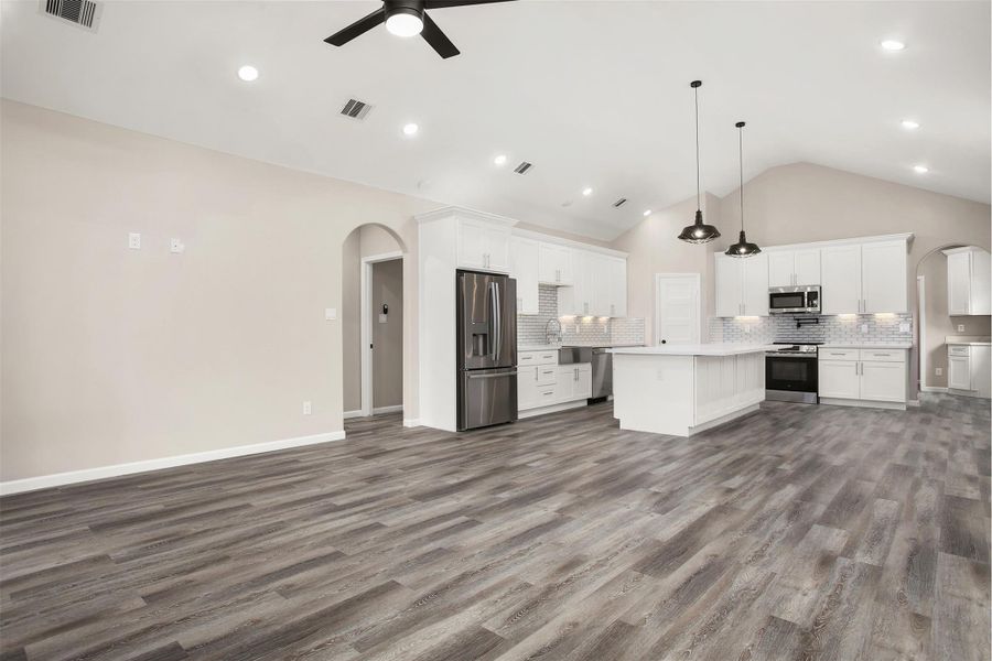 Living room and kitchen with faulted ceiling