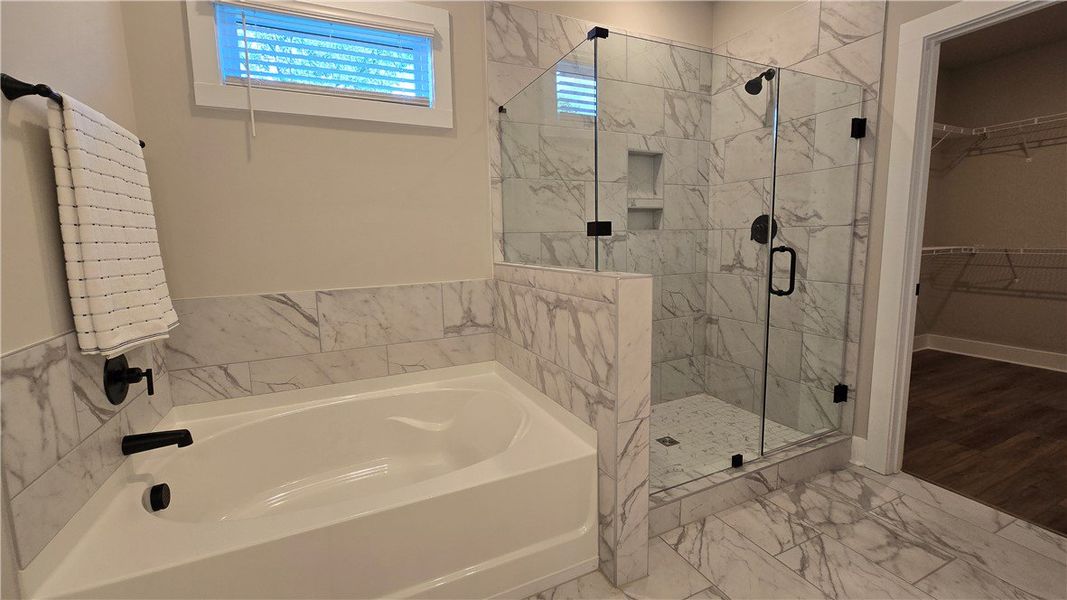 Indulge in a luxurious primary bathroom featuring Indulge in a luxurious primary bathroom featuring