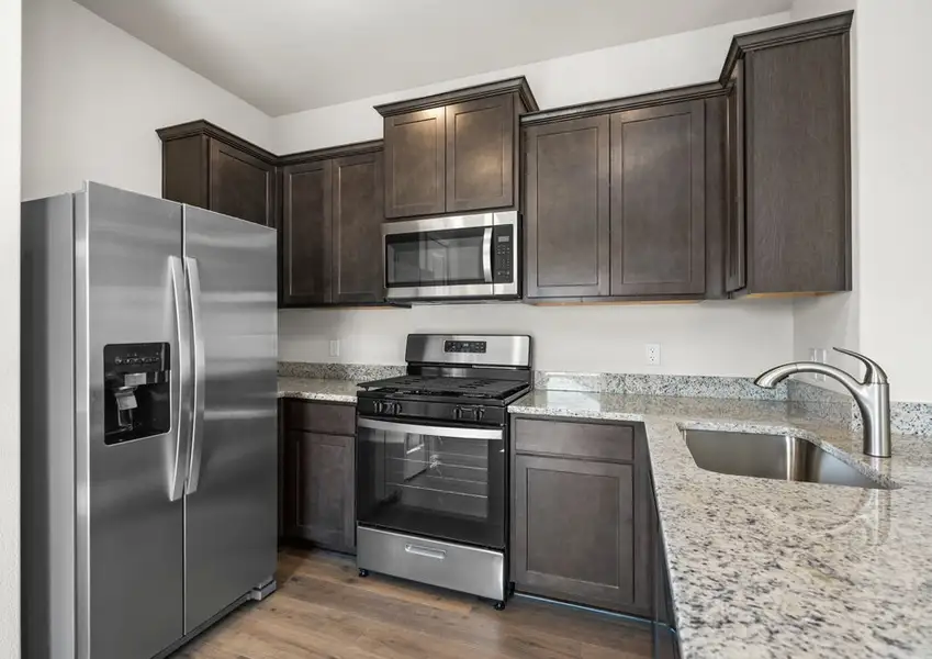 The kitchen has beautiful brown cabinets.