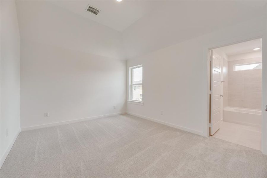 Unfurnished bedroom featuring multiple windows, light carpet, and recessed lighting Unfurnished bedroom featuring multiple windows, light carpet, and recessed lighting
