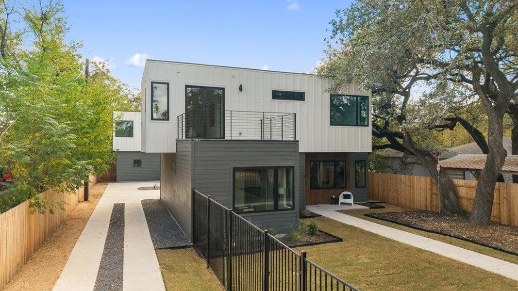 Rear view of property featuring a fenced backyard, a patio area, and a balcony