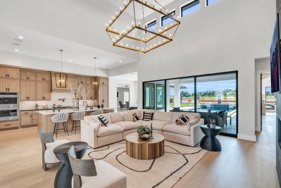 Living room with double height ceiling with glass sliding doors to back porch Living room with double height ceiling with glass sliding doors to back porch