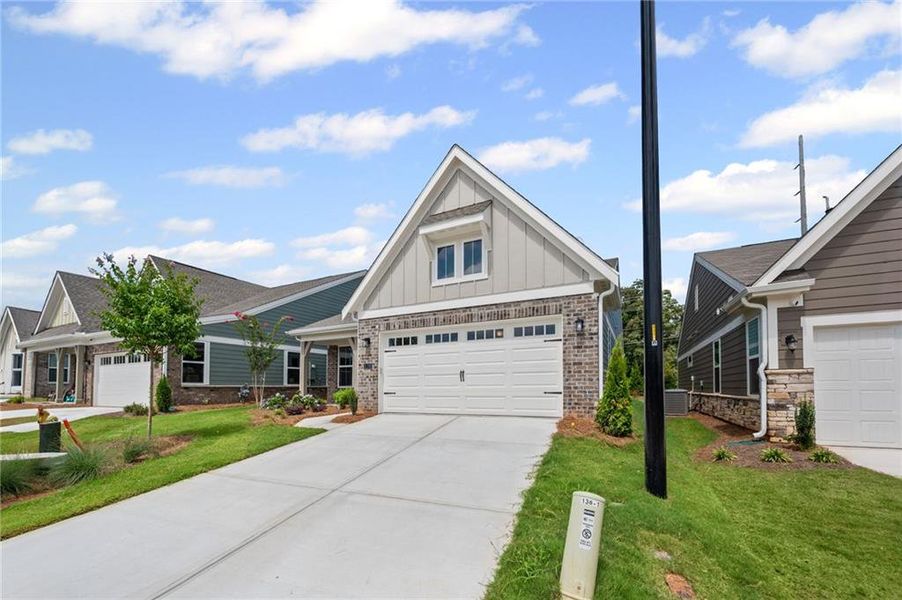 Front exterior of a new home in Laurel Farms, Dallas, GA, highlighting curb appeal (Image 20).