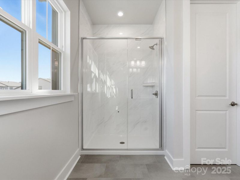 Primary Walk-In Shower With Floor to Ceiling Tile.