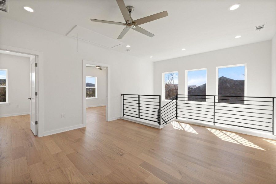 Unfurnished room featuring attic access, light wood flooring, visible vents, and recessed lighting