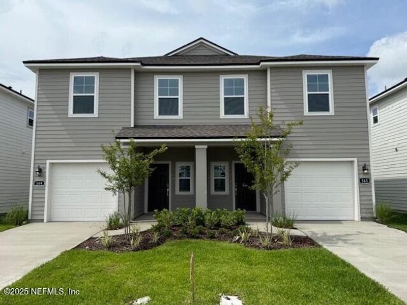 Front exterior of a new home in , Jacksonville, FL, highlighting curb appeal (Image 1).