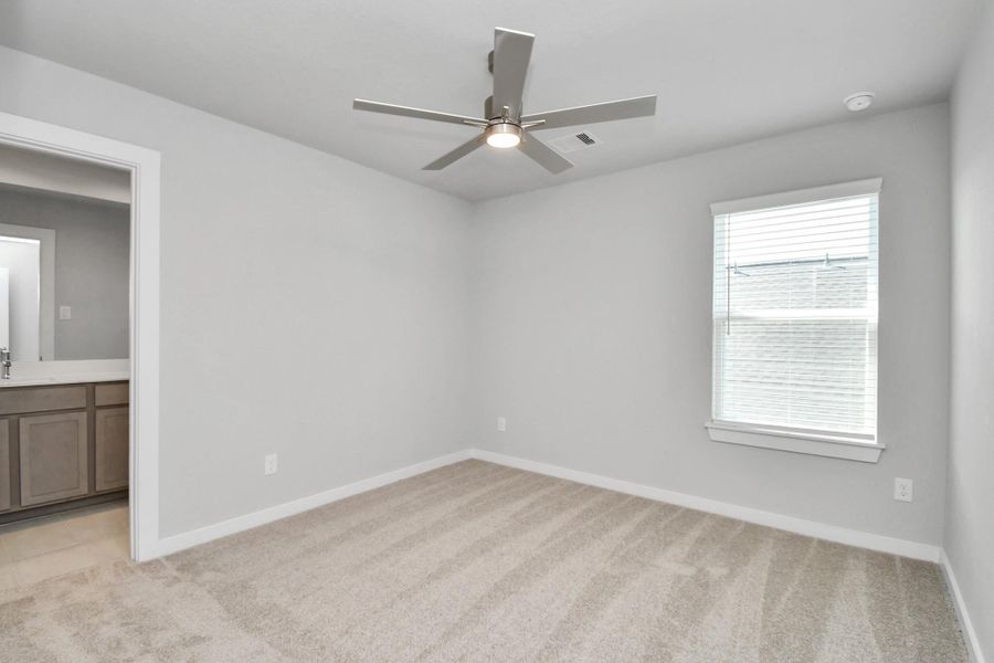 Secondary bedroom features plush carpeting, large windows that let in plenty of natural light, bright paint, and spacious closets. Sample photo of completed home with similar floor plan. Actual colors and selections may vary. Secondary bedroom features plush carpeting, large windows that let in plenty of natural light, bright paint, and spacious closets. Sample photo of completed home with similar floor plan. Actual colors and selections may vary.