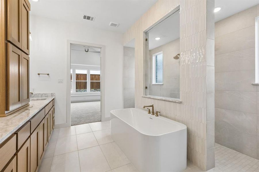Featuring our signature bath with free standing tub and double walk through shower, you'll enjoy a spa like experience every day in this dream home!