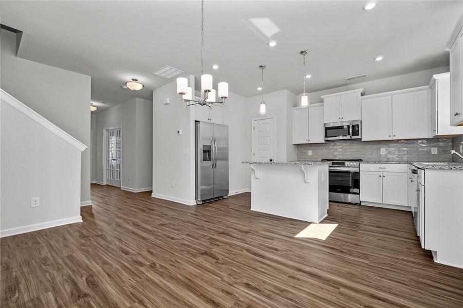 The Coleman- Dining Area into Kitchen. Home under construction, photo used for illustrative purposes only, colors and options will vary. The Coleman- Dining Area into Kitchen. Home under construction, photo used for illustrative purposes only, colors and options will vary.
