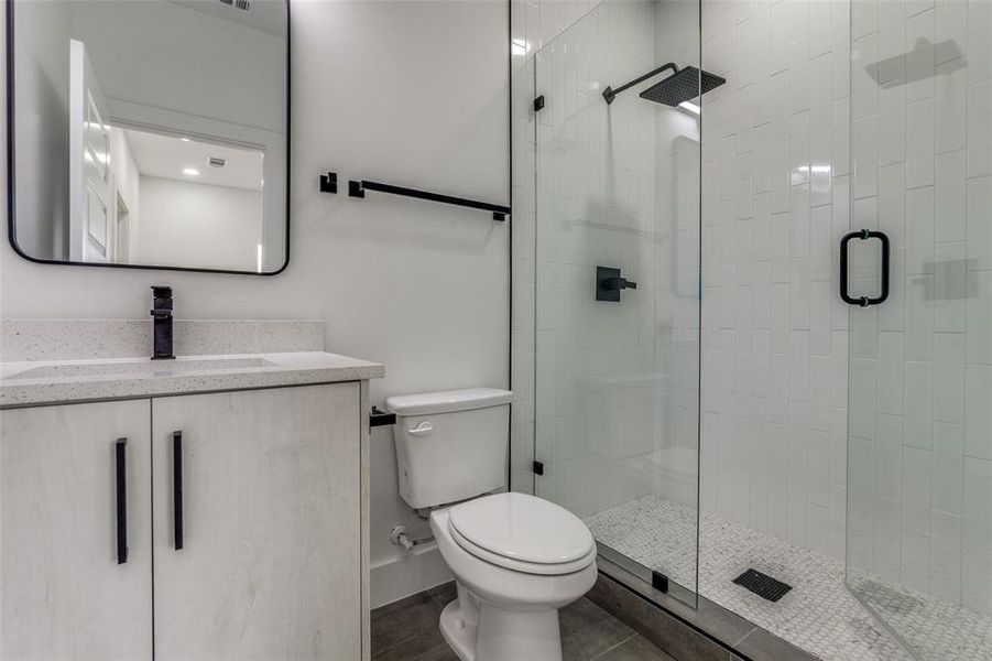 Second full bath with toilet, a stall shower, and vanity