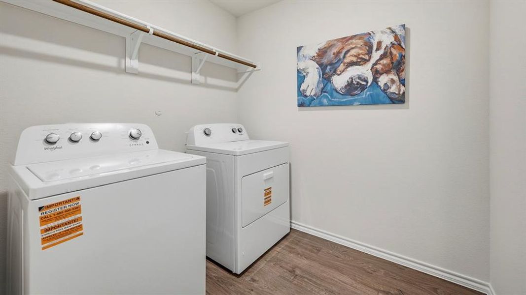 Laundry room featuring dark wood-style flooring and washing machine and clothes dryer Laundry room featuring dark wood-style flooring and washing machine and clothes dryer