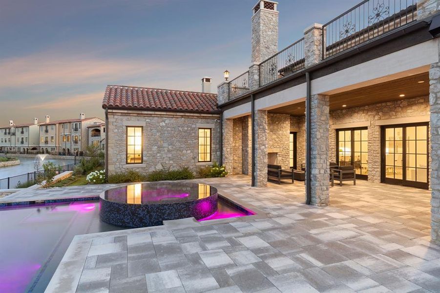 Pool at dusk with a patio area