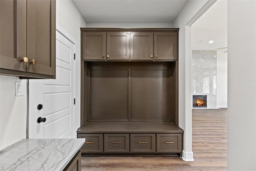 Mud Room featuring light wood-style floors, a fireplace, and recessed lighting Mud Room featuring light wood-style floors, a fireplace, and recessed lighting